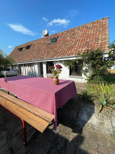 a table with a pink table cloth on it at Chez Jeannot in Vron