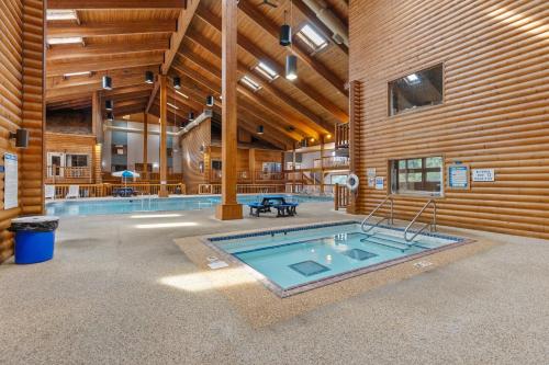 a swimming pool in a room with a wooden wall at The Lodges at Breezy Point in Breezy Point