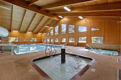 a large pool in a large room with a large building at The Lodges at Breezy Point in Breezy Point