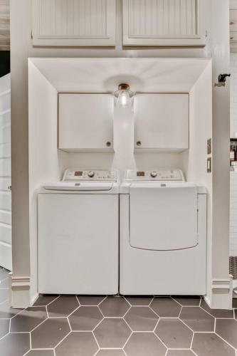 a kitchen with white cabinets and white appliances at City Oasis Awaits Cozy DT Home With Hot Tub Vikings in Minneapolis