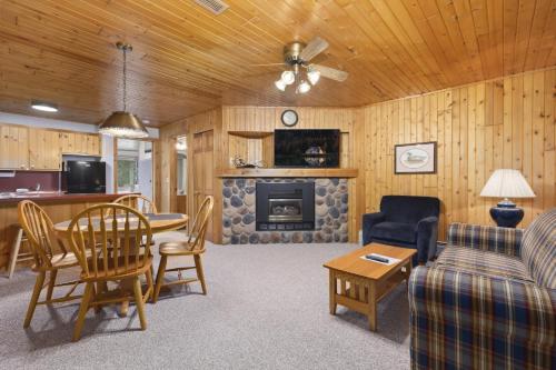 a living room with a couch a table and a fireplace at The Lodges at Breezy Point in Breezy Point