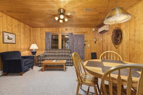 a living room with a table and a couch at The Lodges at Breezy Point in Breezy Point