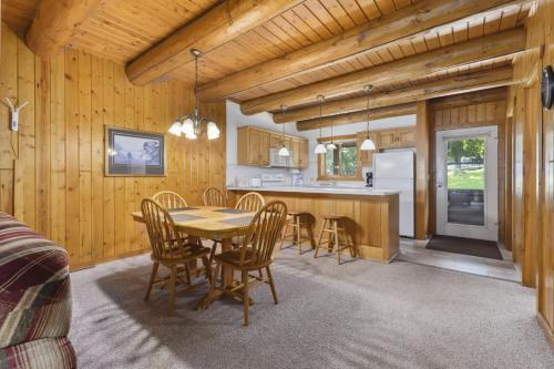 a kitchen and dining room with a table and chairs at The Lodges at Breezy Point in Breezy Point