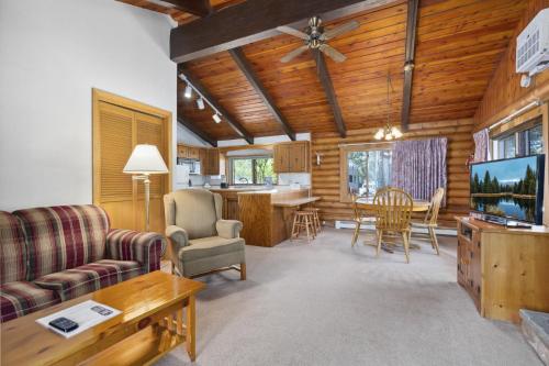 a living room with a couch and a dining room at The Lodges at Breezy Point in Breezy Point