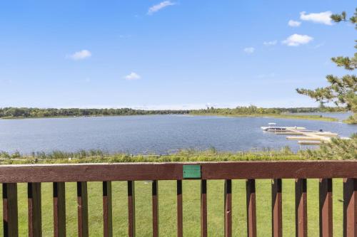 a wooden bench with a view of a lake at The Lodges at Breezy Point in Breezy Point