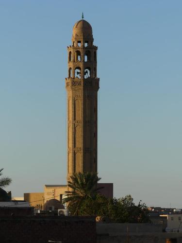 a clock tower in the middle of a city at Dar Fatima in Tozeur