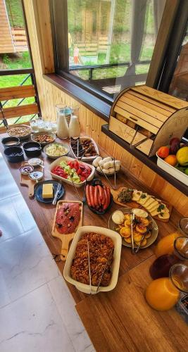 a table with many plates of food on it at Krikhi Village in Ambrolauri