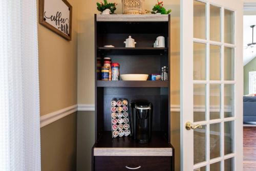 a black cabinet with a coffee maker in a room at Waterfront Cabin With A View, Large Family Retreat, Pet Friendly in Warsaw