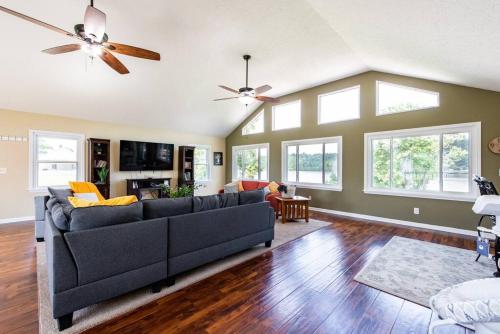 a living room with a couch and a ceiling fan at Waterfront Cabin With A View, Large Family Retreat, Pet Friendly in Warsaw