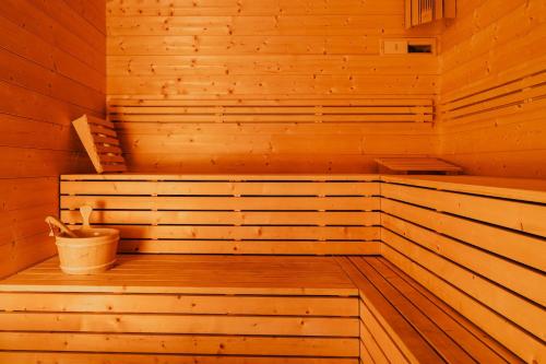a wooden sauna with a bucket in it at Lima Alpine Lodges - Almhaus Gertraud & Theresia in Kanzelhöhe