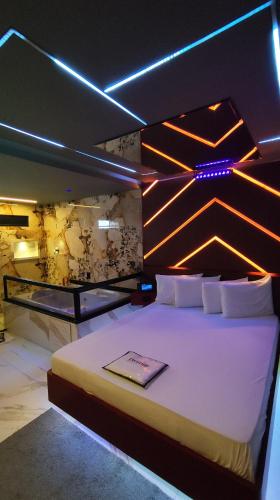 a bedroom with a large bed with lights on it at Prestige Motel 5 in São Paulo