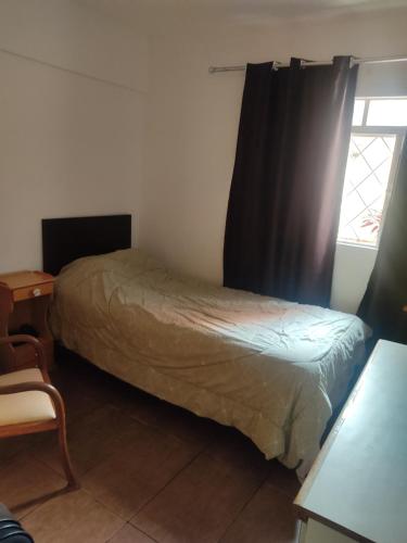 a bedroom with a bed and a window at Moema in Sao Paulo