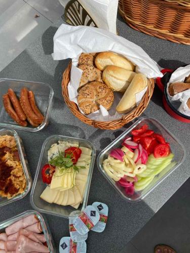 a table with four plastic containers of different types of food at Nyárfás Panoráma Vendégház in Dunavarsány