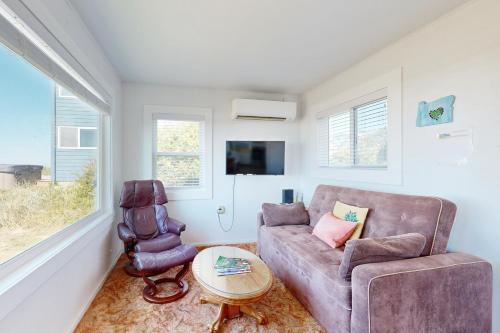 a living room with a couch and a chair at Breakers Cottage in Rockaway Beach