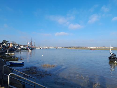 a large body of water with boats in it at Hill Top Hideaway Shepherds Hut with Hot Tub in Woodham Mortimer