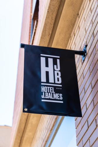 a sign hanging on the side of a building at Hotel J. Balmes Vic in Vic