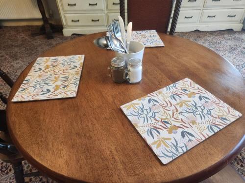 a wooden table with two napkins on top of it at Langley Inn in Bristol