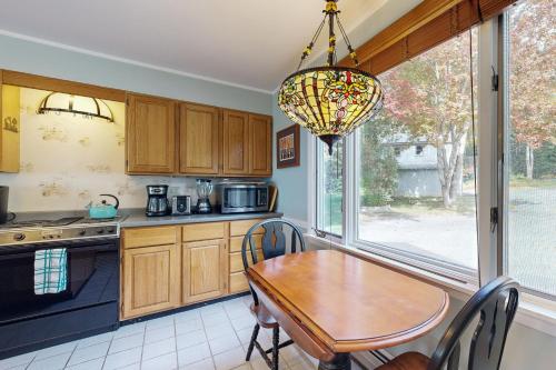 a kitchen with a table and a chandelier at Waterfront Oasis in Trenton