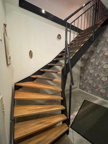 a staircase in a house with black and wooden treads at Hirschblick in Gronau