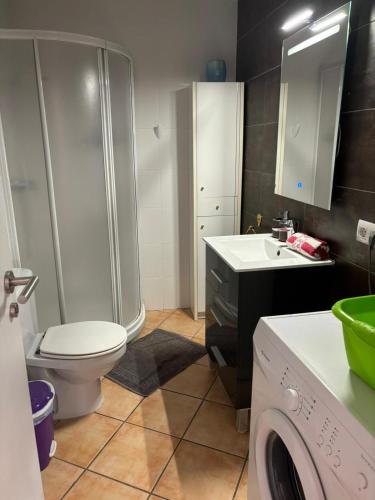 a bathroom with a shower toilet and a washing machine at Apartamento tosca mar con balcon 421 in Moraira