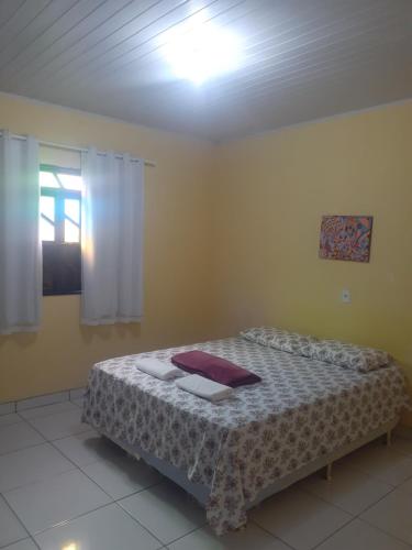 a bedroom with a bed and a light on the ceiling at Casa do Ed in Lençóis
