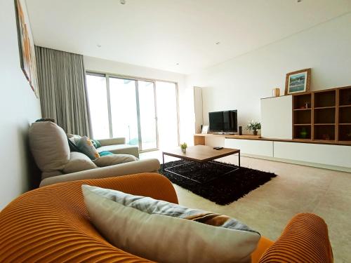 a living room with a couch and a tv at Holiday House Caetano in Ponta do Sol