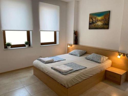 a bedroom with a bed with two pillows on it at Sunny Villa in Byala