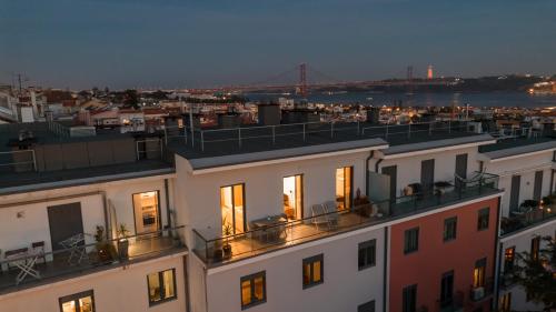 a view of a building with a bridge in the background at Premium Flat at Ajuda/Belém with Balcony, Parking! in Lisbon