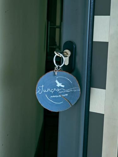 a key chain is attached to a door at Junção - Apartamentos Completos in Miranda do Douro