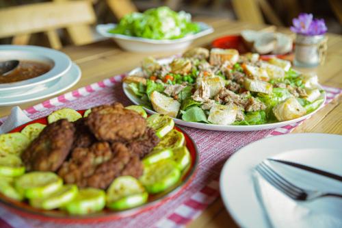 a table with plates of food on a table at Guest House Golijski Dar in Dajići