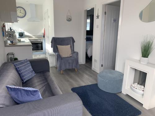 a living room with a couch and a fireplace at Isla's Haven Holiday Chalet in Bridlington