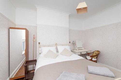 a bedroom with a bed with a mirror and a sink at Characterful Terrace Retreat in County Durham - Sleeps 6 in Stanley