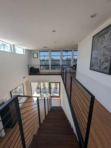 a staircase in a house with wooden floors and windows at 4Bed Arcadia Pool&HT close to oldtown Scottsdale in Phoenix