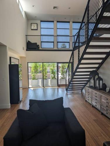 a living room with a couch and a staircase at 4Bed Arcadia Pool&HT close to oldtown Scottsdale in Phoenix