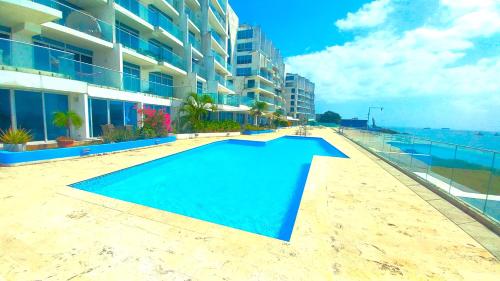 a swimming pool in front of a building at Apartment in the Causeway Amador in Panama City