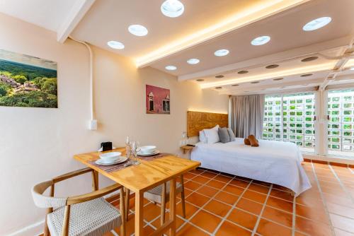 a hotel room with a bed and a table at Casa Jicama in Cancún
