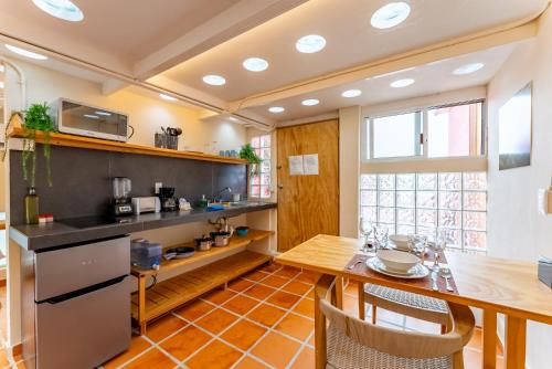 a kitchen with a wooden table and a dining room at Casa Jicama in Cancún