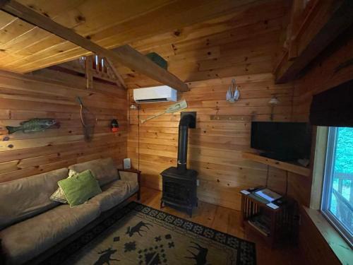 un soggiorno con divano e piano cottura di Wild Fox Cabins a The Pines