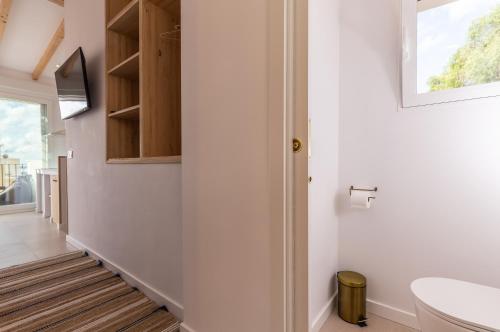 a hallway with a bathroom with a toilet and a window at Mediterranean Loft in Alicante