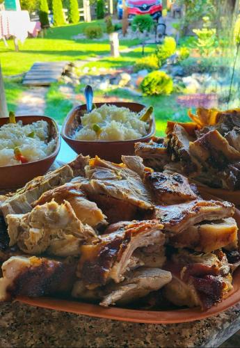 a plate of food with two bowls of food at Seosko domaćinstvo „GABAR” in Ćuštica