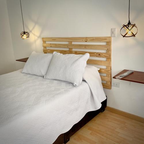 a bedroom with a bed with two white pillows at Apartaestudio Loft 203 - UE Home in Duitama