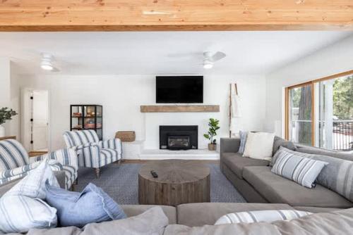 a living room with a couch and a fireplace at Luxury Lake Home-The Bear Claw-Boat Slip-Sleeps 16 in Bass Lake