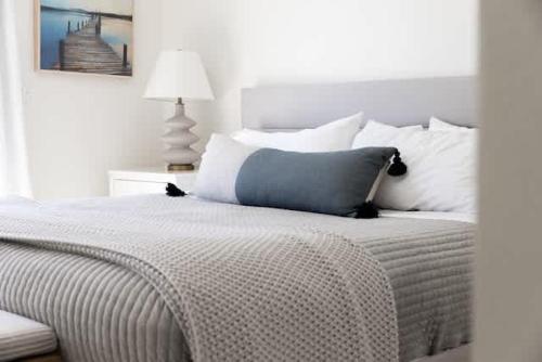 a white bedroom with a bed with white pillows at Luxury Lake Home-The Bear Claw-Boat Slip-Sleeps 16 in Bass Lake