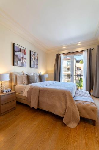 a large bedroom with a large bed and a window at Porto Montenegro in Tivat