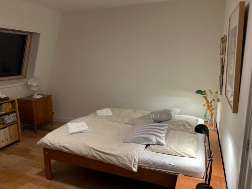 a bedroom with a bed with a lamp and a television at just like home in Haarlem