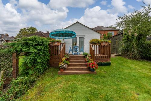 a house with a staircase with a blue umbrella at 1 bed house in Hampshire in Chandlers Ford