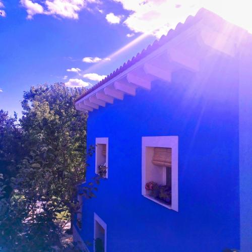 a blue building with two windows on the side of it at Loft La buena vida in Peñaranda de Duero