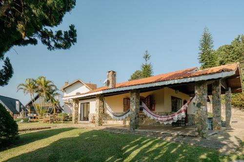 an image of a house with a yard at Pousada das Pedras in Monte Verde