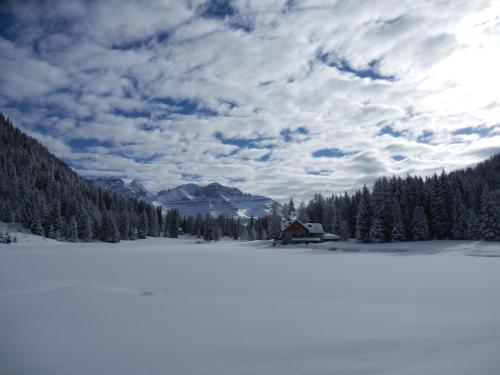 
a snowy mountain with a view of the ocean at Rifugio Lago Nambino in Madonna di Campiglio
