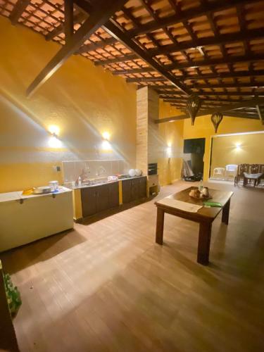 a large room with a table and a kitchen at Casa Amarilla Alter in Alter do Chao